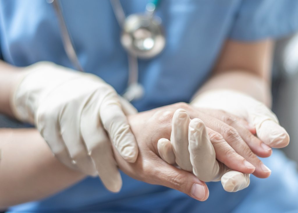 Surgeon surgical doctor anesthetist or anesthesiologist holding patients hand for health care trust and support in professional surgical operation medical anesthetic safety healthcare concept | FEW.ae