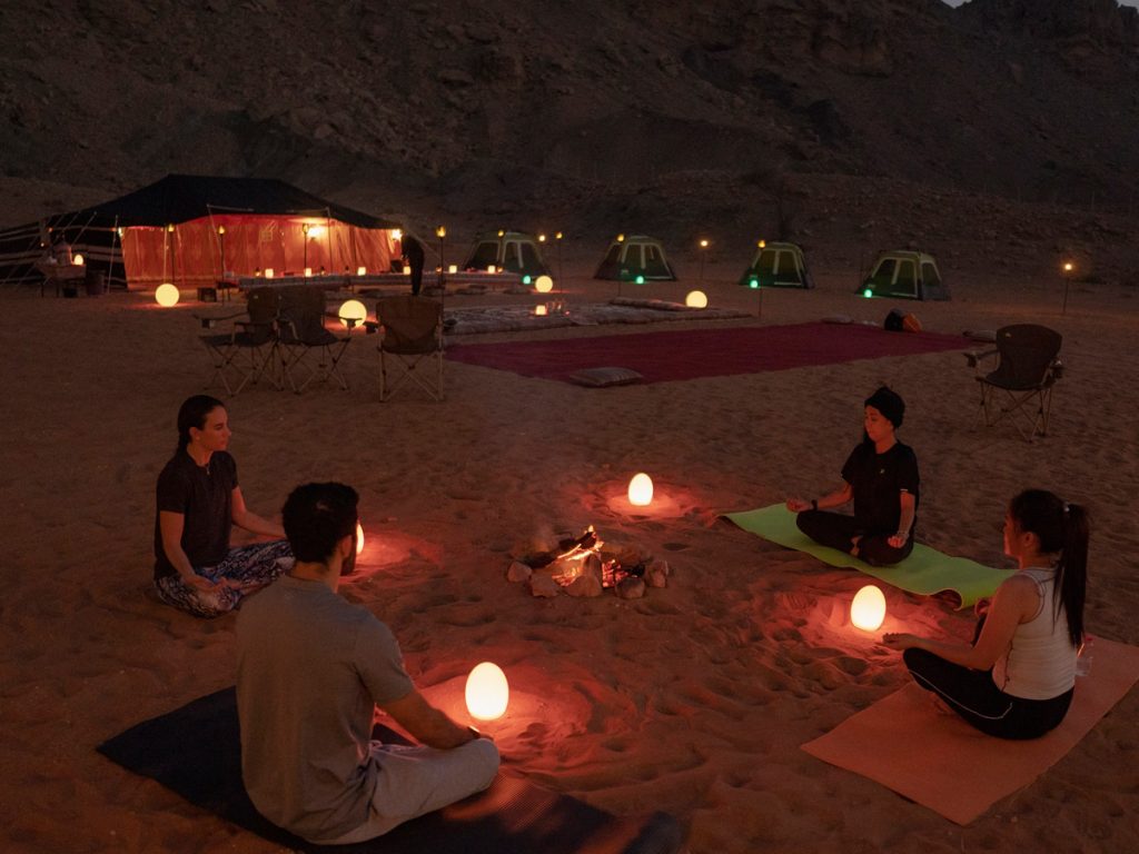 How to book a sunrise desert yoga class in Abu Dhabi?